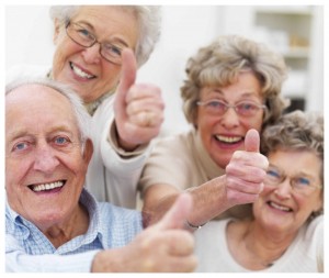 Happy elderly people wearing hearing aids